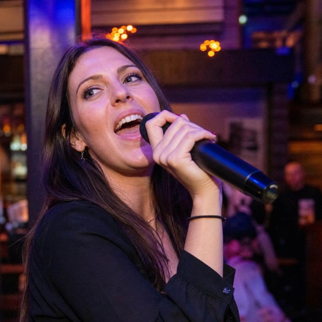Singer performing over a full vocal mix